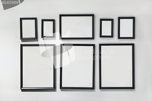 Image of Blank picture frames on white wall