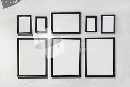 Image of Blank picture frames on white wall