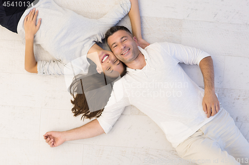 Image of handsome couple lying on floor