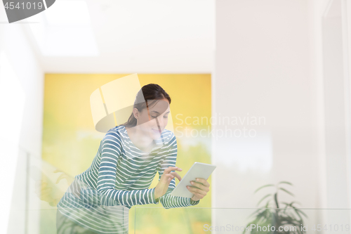 Image of young woman at home websurfing