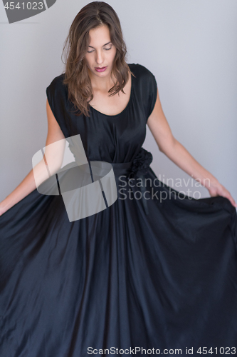 Image of woman in a black dress isolated on white background