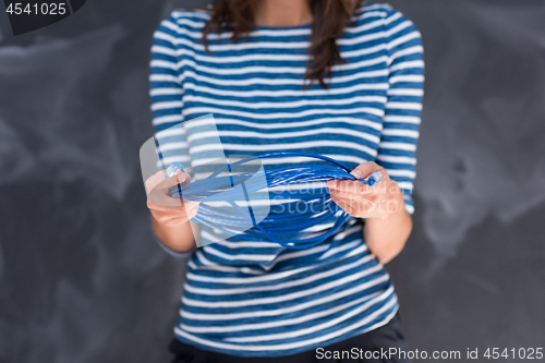 Image of woman holding a internet cable in front of chalk drawing board