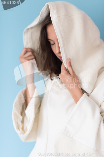 Image of woman in a white coat with hood isolated on blue background