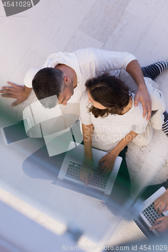Image of couple using tablet and laptop computers top view