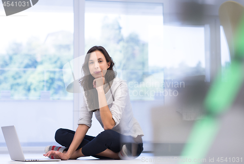 Image of young women using laptop computer on the floor