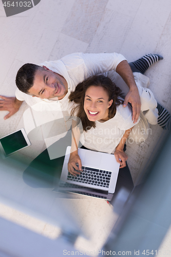 Image of couple using tablet and laptop computers top view