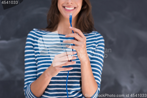 Image of woman holding a internet cable in front of chalk drawing board