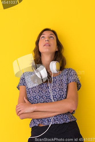 Image of woman with headphones isolated on a yellow