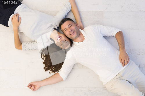 Image of handsome couple lying on floor