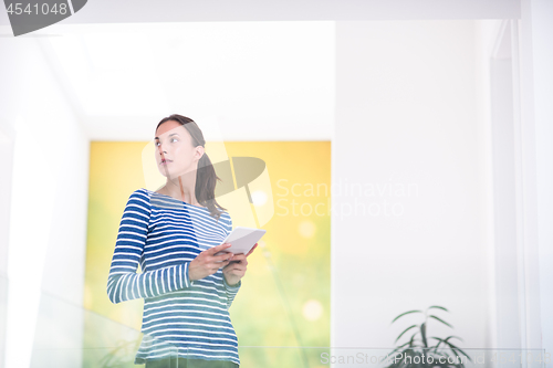 Image of young woman at home websurfing