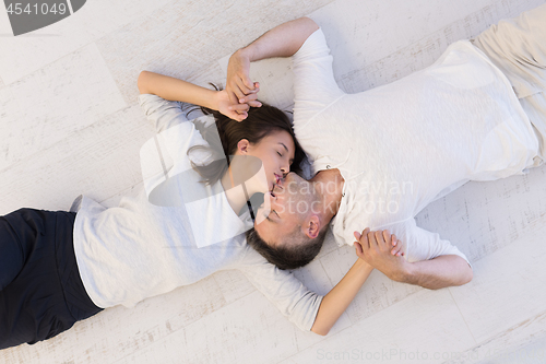 Image of handsome couple lying on floor