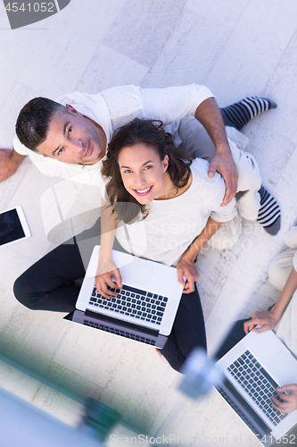 Image of couple using tablet and laptop computers top view