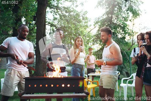 Image of Group of friends making barbecue in the backyard. concept about good and positive mood with friends