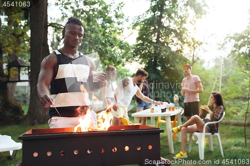 Image of Group of friends making barbecue in the backyard. concept about good and positive mood with friends