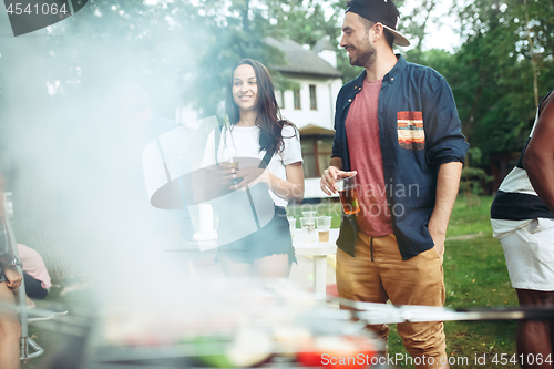 Image of Group of friends making barbecue in the backyard. concept about good and positive mood with friends