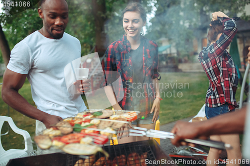 Image of Group of friends making barbecue in the backyard. concept about good and positive mood with friends