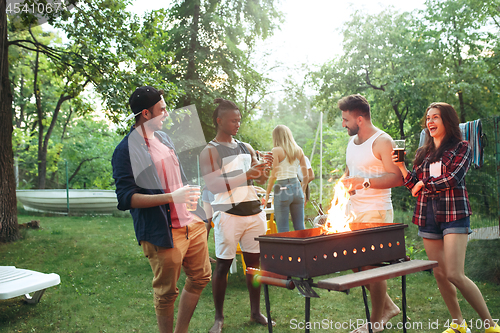 Image of Group of friends making barbecue in the backyard. concept about good and positive mood with friends