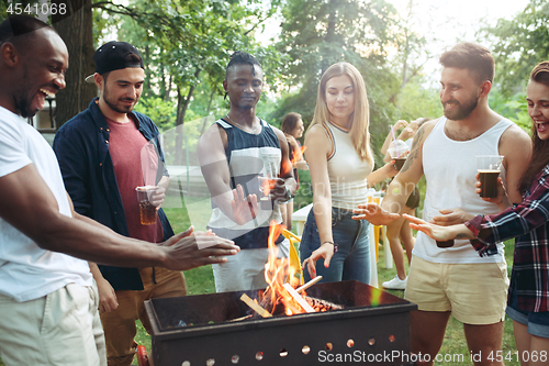 Image of Group of friends making barbecue in the backyard. concept about good and positive mood with friends