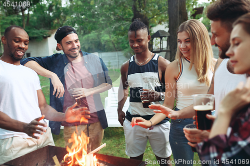 Image of Group of friends making barbecue in the backyard. concept about good and positive mood with friends