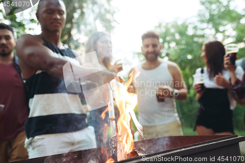 Image of Group of friends making barbecue in the backyard. concept about good and positive mood with friends