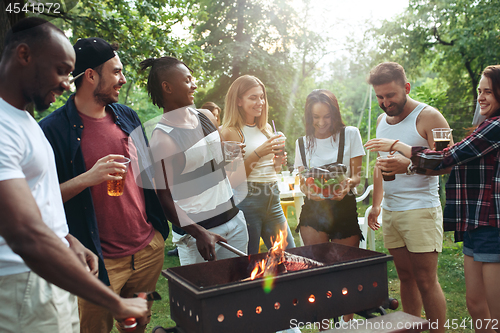 Image of Group of friends making barbecue in the backyard. concept about good and positive mood with friends