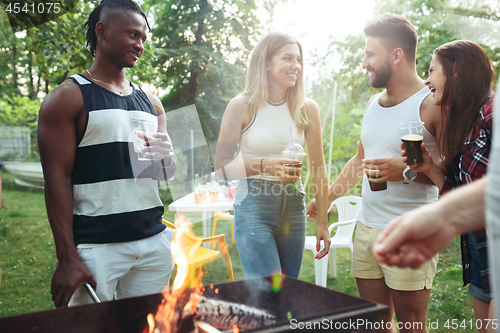 Image of Group of friends making barbecue in the backyard. concept about good and positive mood with friends