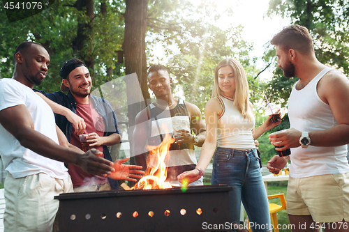 Image of Group of friends making barbecue in the backyard. concept about good and positive mood with friends