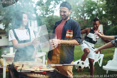 Image of Group of friends making barbecue in the backyard. concept about good and positive mood with friends