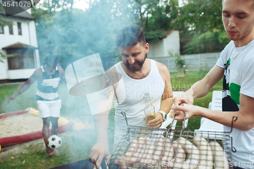 Image of Group of friends making barbecue in the backyard. concept about good and positive mood with friends