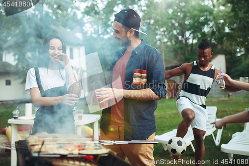 Image of Group of friends making barbecue in the backyard. concept about good and positive mood with friends