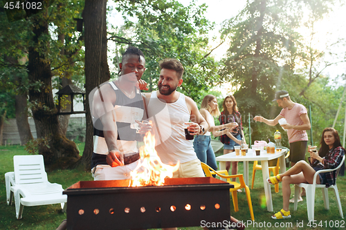 Image of Group of friends making barbecue in the backyard. concept about good and positive mood with friends