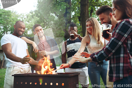 Image of Group of friends making barbecue in the backyard. concept about good and positive mood with friends