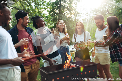 Image of Group of friends making barbecue in the backyard. concept about good and positive mood with friends