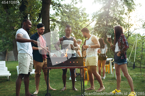 Image of Group of friends making barbecue in the backyard. concept about good and positive mood with friends
