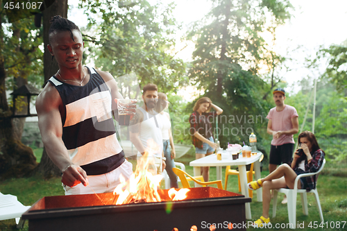 Image of Group of friends making barbecue in the backyard. concept about good and positive mood with friends