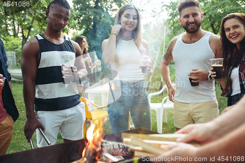 Image of Group of friends making barbecue in the backyard. concept about good and positive mood with friends