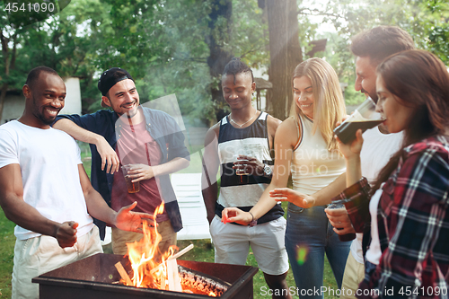 Image of Group of friends making barbecue in the backyard. concept about good and positive mood with friends