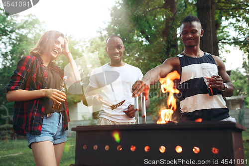 Image of Group of friends making barbecue in the backyard. concept about good and positive mood with friends