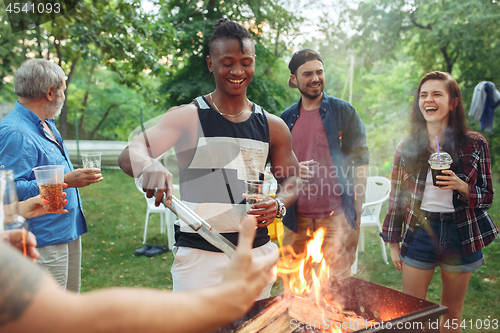 Image of Group of friends making barbecue in the backyard. concept about good and positive mood with friends