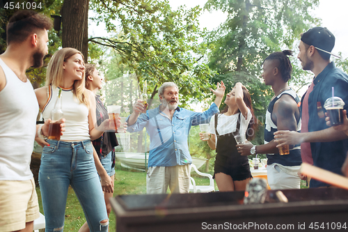 Image of Group of friends making barbecue in the backyard. concept about good and positive mood with friends