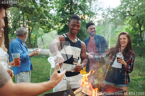 Image of Group of friends making barbecue in the backyard. concept about good and positive mood with friends