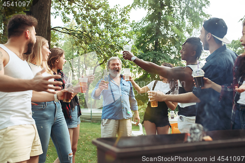 Image of Group of friends making barbecue in the backyard. concept about good and positive mood with friends