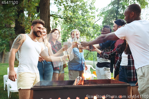 Image of Group of friends making barbecue in the backyard. concept about good and positive mood with friends