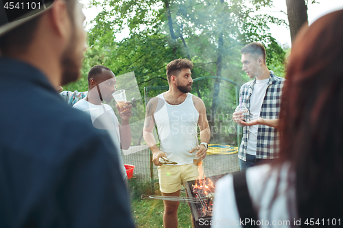 Image of Group of friends making barbecue in the backyard. concept about good and positive mood with friends