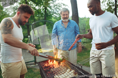 Image of Group of friends making barbecue in the backyard. concept about good and positive mood with friends