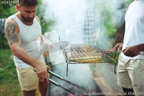 Image of Group of friends making barbecue in the backyard. concept about good and positive mood with friends