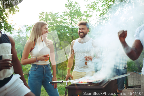 Image of Group of friends making barbecue in the backyard. concept about good and positive mood with friends