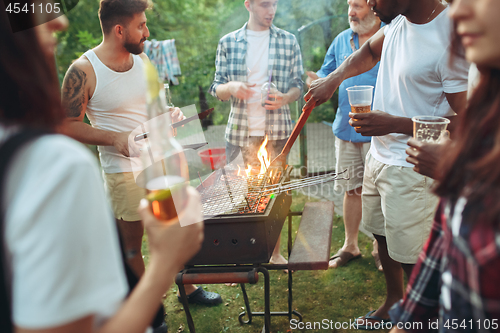 Image of Group of friends making barbecue in the backyard. concept about good and positive mood with friends