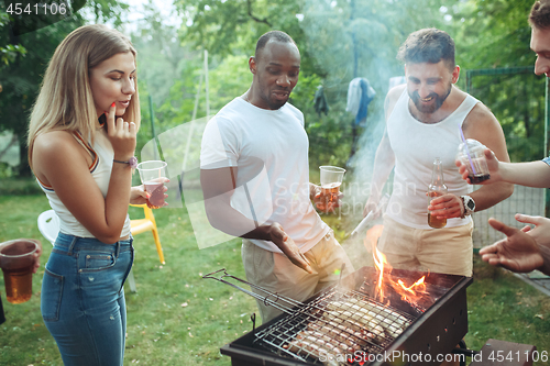 Image of Group of friends making barbecue in the backyard. concept about good and positive mood with friends