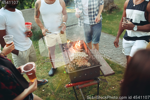 Image of Group of friends making barbecue in the backyard. concept about good and positive mood with friends